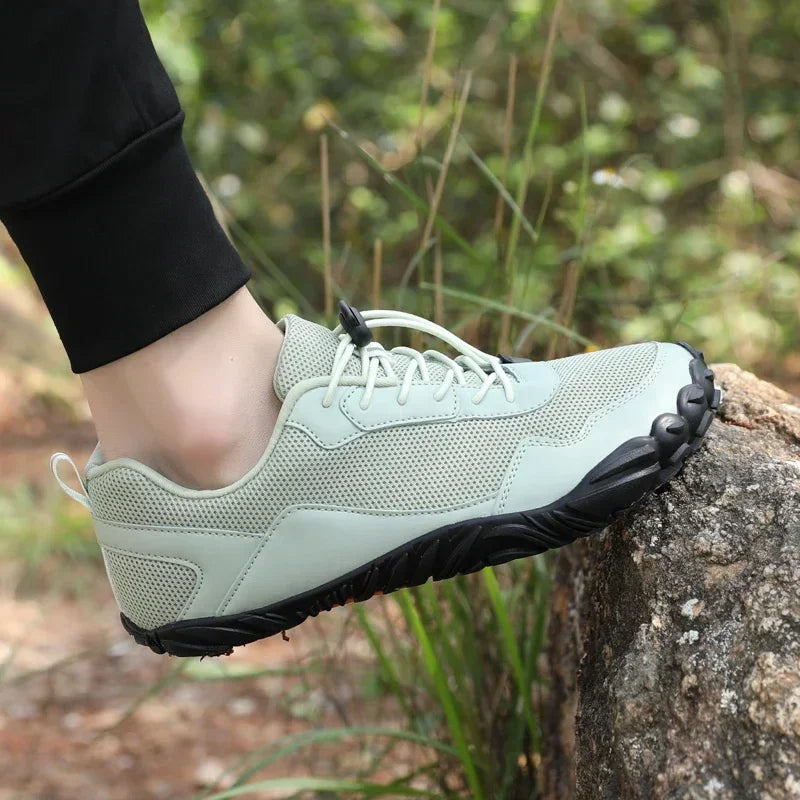 A person in sneakers on a rock - Joyo barefoot