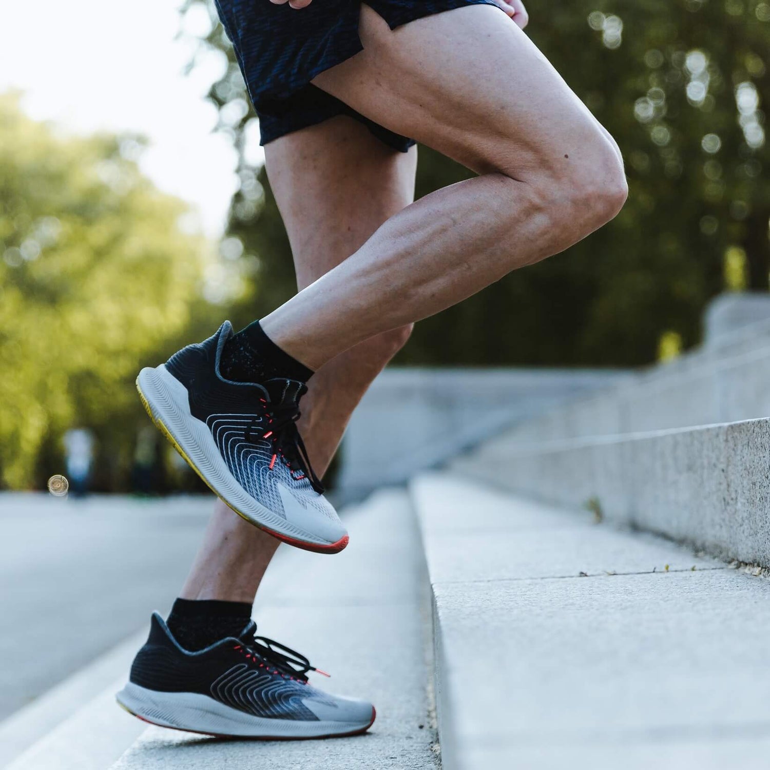 A man runs up a stairway with shoes—Joyo barefoot